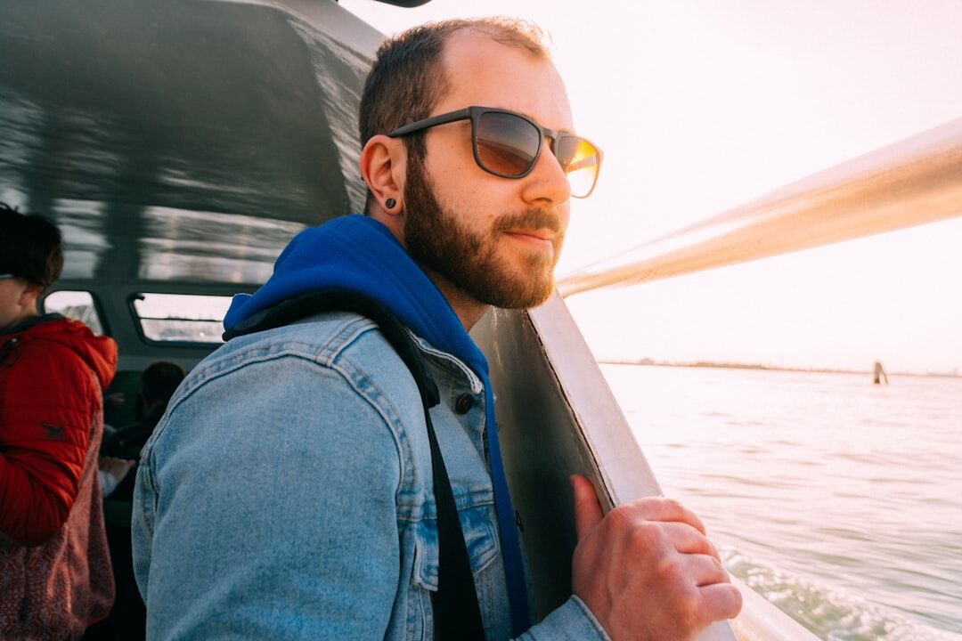 Man wearing polarized sunglasses on a boat deck at the coast of Uruguay