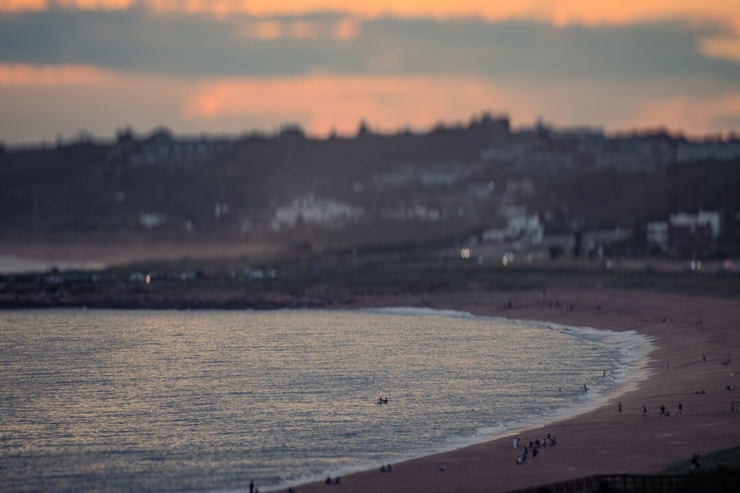 Golden hour view of Punta del Este coastline with a luxury chronograph watch in foreground
