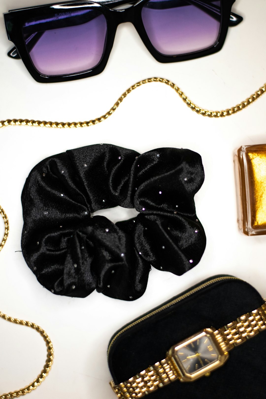 Gold-frame eyeglasses with mother-of-pearl detail on velvet fabric